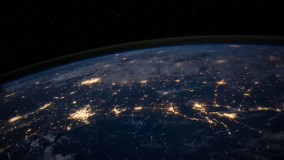 Earth at night from space showing global network connectivity and data center infrastructure